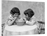 1930s two girls playing blowing soap bubble pipes by Anonymous