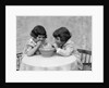 1930s two girls playing blowing soap bubble pipes by Anonymous