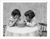 1930s two girls playing blowing soap bubble pipes by Anonymous