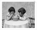 1930s two girls playing blowing soap bubble pipes by Anonymous