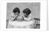 1930s two girls playing blowing soap bubble pipes by Anonymous