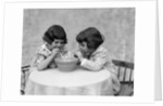 1930s two girls playing blowing soap bubble pipes by Anonymous