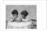 1930s two girls playing blowing soap bubble pipes by Anonymous