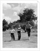 1950s three girls running in grassy field by Anonymous