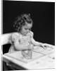 1960s 1940s girl child sitting at desk drawing coloring pictures by Anonymous