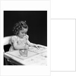 1960s 1940s girl child sitting at desk drawing coloring pictures by Anonymous