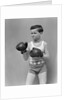 1940s boy child wearing boxing gloves standing ready to fight by Anonymous