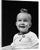 1940s smiling blond boy with big curl on top of head looking up by Anonymous