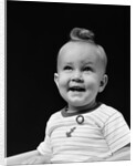 1940s smiling blond boy with big curl on top of head looking up by Anonymous