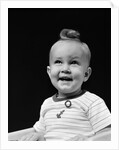 1940s smiling blond boy with big curl on top of head looking up by Anonymous