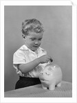 1950slittle boy putting coin into piggy bank by Anonymous