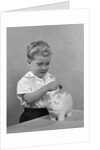 1950slittle boy putting coin into piggy bank by Anonymous