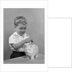 1950slittle boy putting coin into piggy bank by Anonymous