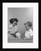 1950s little girl and boy putting coin into piggy bank by Anonymous