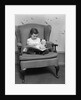 1930s little girl child in large chair with bear reading book by Anonymous