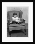 1930s little girl child in large chair with bear reading book by Anonymous