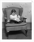 1930s little girl child in large chair with bear reading book by Anonymous
