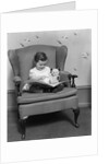 1930s little girl child in large chair with bear reading book by Anonymous