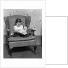 1930s little girl child in large chair with bear reading book by Anonymous