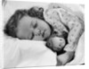 1950s child little girl sleeping in bed with doll by Anonymous