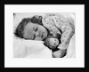1950s child little girl sleeping in bed with doll by Anonymous