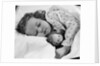 1950s child little girl sleeping in bed with doll by Anonymous