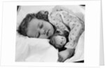 1950s child little girl sleeping in bed with doll by Anonymous