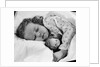 1950s child little girl sleeping in bed with doll by Anonymous