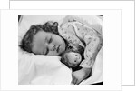 1950s child little girl sleeping in bed with doll by Anonymous