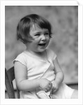 1930s smiling laughing toddler girl holding shoe by Anonymous