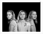 1950s 1960s multiple exposure girl going from happy to sad three facial expressions looking at camera by Anonymous