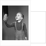 1960s boy holding adult male hand smiling by Anonymous