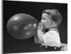 1940s boy blowing up balloon by Anonymous