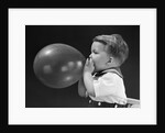 1940s boy blowing up balloon by Anonymous