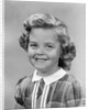 1950s portrait smiling girl with white collar plaid dress looking at camera by Anonymous