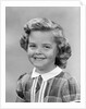 1950s portrait smiling girl with white collar plaid dress looking at camera by Anonymous