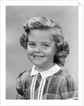 1950s portrait smiling girl with white collar plaid dress looking at camera by Anonymous