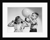 1950s little boy blowing up big balloon little girl with fingers in ears eyes closed by Anonymous