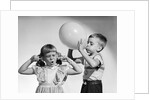 1950s little boy blowing up big balloon little girl with fingers in ears eyes closed by Anonymous