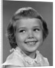 1960s smiling girl looking off to the side by Anonymous