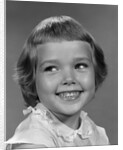 1960s smiling girl looking off to the side by Anonymous