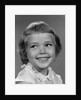 1960s smiling girl looking off to the side by Anonymous