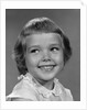 1960s smiling girl looking off to the side by Anonymous