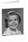 1960s smiling girl looking off to the side by Anonymous