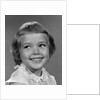 1960s smiling girl looking off to the side by Anonymous