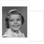 1960s smiling girl looking off to the side by Anonymous