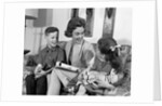 1960s mother sitting on couch with son and daughter by Anonymous