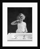 1930s child curly hair blond girl brushing teeth toothbrush looking at camera by Anonymous