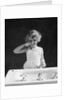 1930s child curly hair blond girl brushing teeth toothbrush looking at camera by Anonymous