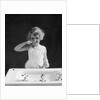 1930s child curly hair blond girl brushing teeth toothbrush looking at camera by Anonymous
